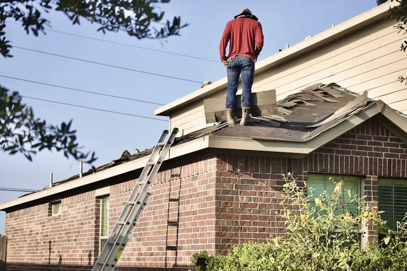 Professional roofer working on a residential roof in Rebel Hill